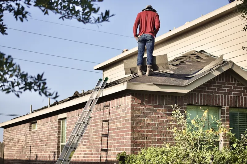 Professional roofer working on a residential roof in Brookfield